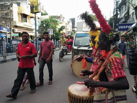 Tribal community people who work in the tea garden collect donations for the upcoming 'Dashai Puja,' which is celebrated during the Dusshera...