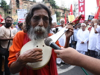 An Indian folk singer sings a song before the Communist Party of India (Marxist), West Bengal starts a protest march amid the ongoing confli...