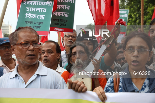 The Communist Party of India (Marxist), West Bengal, holds posters and shouts slogans during a protest march amid the ongoing conflict in Ga...