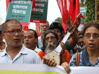 The Communist Party of India (Marxist), West Bengal, holds posters and shouts slogans during a protest march amid the ongoing conflict in Ga...