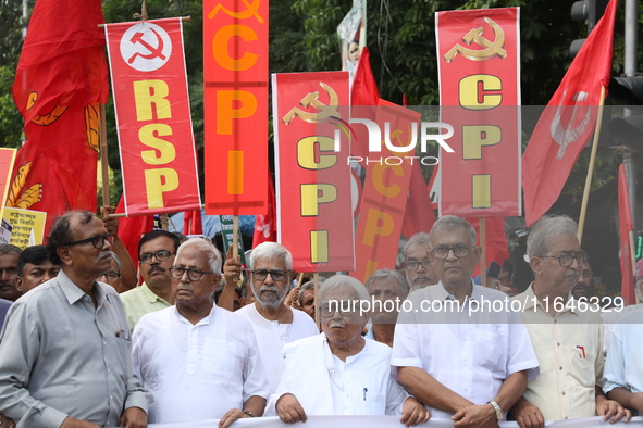 The Communist Party of India (Marxist), West Bengal, holds posters and shouts slogans during a protest march amid the ongoing conflict in Ga...