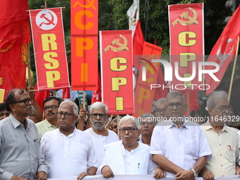 The Communist Party of India (Marxist), West Bengal, holds posters and shouts slogans during a protest march amid the ongoing conflict in Ga...