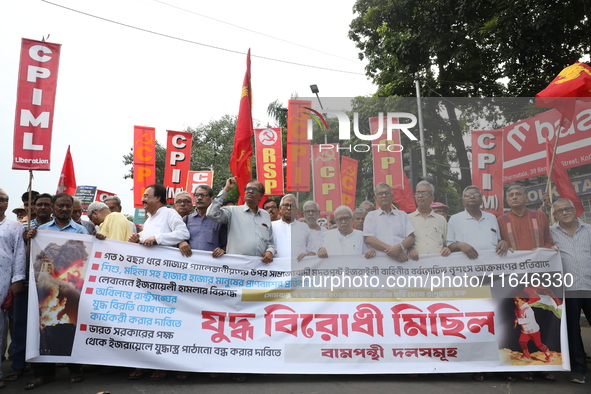 The Communist Party of India (Marxist), West Bengal, holds posters and shouts slogans during a protest march amid the ongoing conflict in Ga...