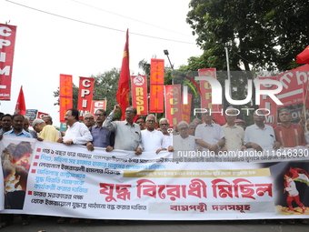 The Communist Party of India (Marxist), West Bengal, holds posters and shouts slogans during a protest march amid the ongoing conflict in Ga...