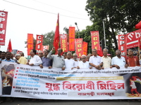 The Communist Party of India (Marxist), West Bengal, holds posters and shouts slogans during a protest march amid the ongoing conflict in Ga...