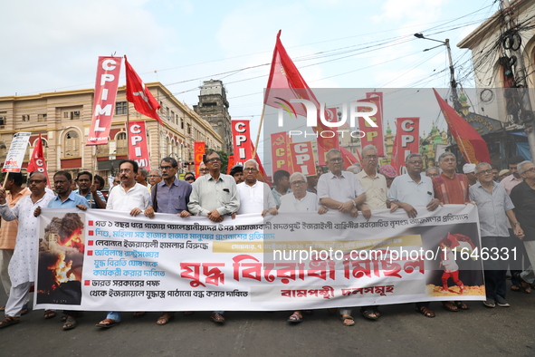 The Communist Party of India (Marxist), West Bengal, holds posters and shouts slogans during a protest march amid the ongoing conflict in Ga...