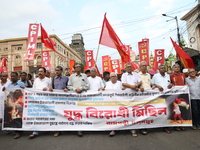 The Communist Party of India (Marxist), West Bengal, holds posters and shouts slogans during a protest march amid the ongoing conflict in Ga...