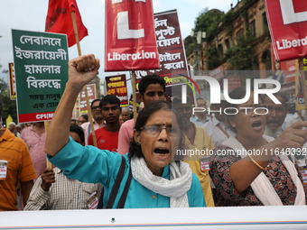 The Communist Party of India (Marxist), West Bengal, holds posters and shouts slogans during a protest march amid the ongoing conflict in Ga...