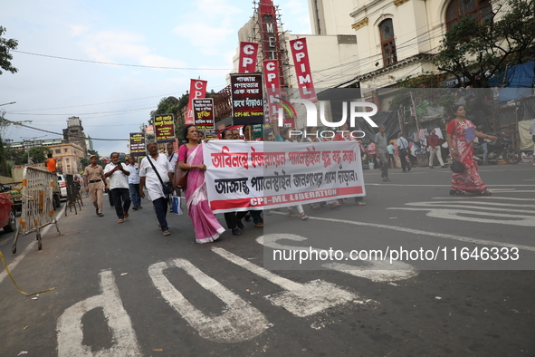 The Communist Party of India (Marxist), West Bengal, holds posters and shouts slogans during a protest march amid the ongoing conflict in Ga...