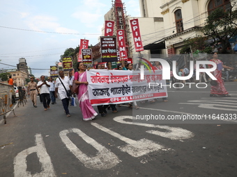 The Communist Party of India (Marxist), West Bengal, holds posters and shouts slogans during a protest march amid the ongoing conflict in Ga...