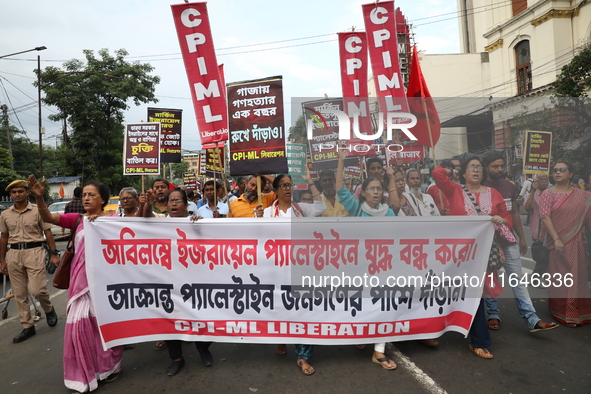 The Communist Party of India (Marxist), West Bengal, holds posters and shouts slogans during a protest amid the ongoing conflict in Gaza bet...