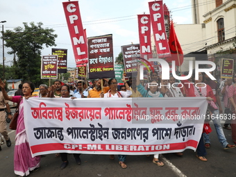 The Communist Party of India (Marxist), West Bengal, holds posters and shouts slogans during a protest amid the ongoing conflict in Gaza bet...