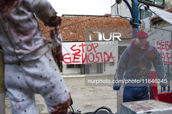 A banner in support of the Palestinian people is seen on a wall in the Liogenteng settlement area in Bandung, West Java, Indonesia, on Octob...