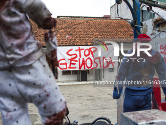 A banner in support of the Palestinian people is seen on a wall in the Liogenteng settlement area in Bandung, West Java, Indonesia, on Octob...