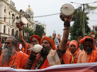 A sadhu, or a Hindu holy man, blows into a conch shell during a protest near a stage where junior doctors hold a hunger strike to protest ag...