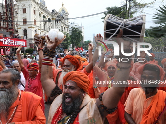 Sadhus or Hindu holy men participate in a protest near a stage where junior doctors hold a hunger strike to protest against the rape and mur...