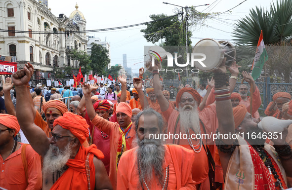 Sadhus or Hindu holy men participate in a protest near a stage where junior doctors hold a hunger strike to protest against the rape and mur...