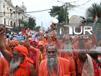 Sadhus or Hindu holy men participate in a protest near a stage where junior doctors hold a hunger strike to protest against the rape and mur...