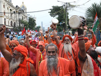 Sadhus or Hindu holy men participate in a protest near a stage where junior doctors hold a hunger strike to protest against the rape and mur...