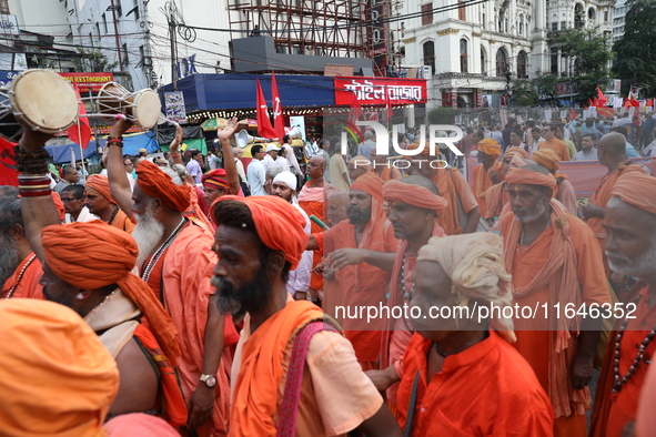 Sadhus or Hindu holy men participate in a protest near a stage where junior doctors hold a hunger strike to protest against the rape and mur...