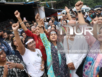 Citizens shout slogans during a protest near a stage where junior doctors hold a hunger strike to protest against the rape and murder of a P...