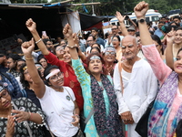 Citizens shout slogans during a protest near a stage where junior doctors hold a hunger strike to protest against the rape and murder of a P...