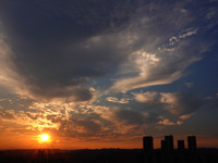 The sun moves through clouds as it sets in the evening in Yichang, China, on October 7, 2024. (