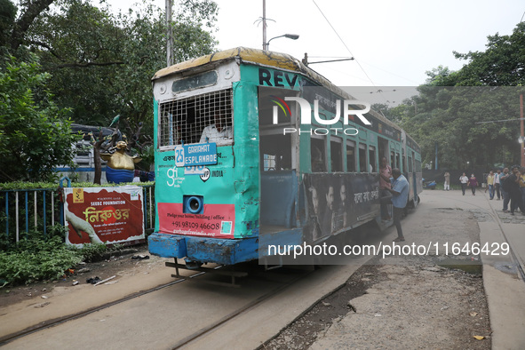 A tram parks at a stop inside its depot for passengers in Kolkata, India, on October 7, 2024. The 150-year-old tram service is a legacy and...