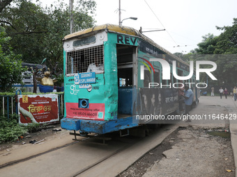 A tram parks at a stop inside its depot for passengers in Kolkata, India, on October 7, 2024. The 150-year-old tram service is a legacy and...