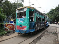 A tram parks at a stop inside its depot for passengers in Kolkata, India, on October 7, 2024. The 150-year-old tram service is a legacy and...