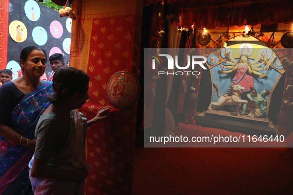 Hindu senior citizen women from an old age home arrive to adorn an idol of the Hindu goddess Durga inside a tram compartment converted to a...