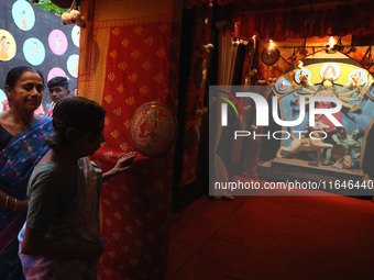 Hindu senior citizen women from an old age home arrive to adorn an idol of the Hindu goddess Durga inside a tram compartment converted to a...