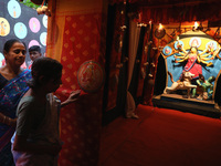 Hindu senior citizen women from an old age home arrive to adorn an idol of the Hindu goddess Durga inside a tram compartment converted to a...