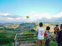 Kids fly kites on the occasion of the Dashain festival in the outskirts of Kathmandu, Nepal, on October 7, 2024. (