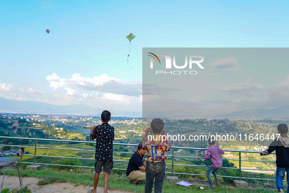 Kids fly kites on the occasion of the Dashain festival in the outskirts of Kathmandu, Nepal, on October 7, 2024. 