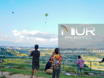 Kids fly kites on the occasion of the Dashain festival in the outskirts of Kathmandu, Nepal, on October 7, 2024. (