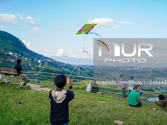 Kids fly kites on the occasion of the Dashain festival in the outskirts of Kathmandu, Nepal, on October 7, 2024. (