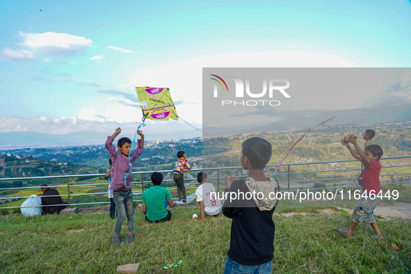 Kids fly kites on the occasion of the Dashain festival in the outskirts of Kathmandu, Nepal, on October 7, 2024. 