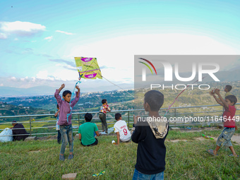 Kids fly kites on the occasion of the Dashain festival in the outskirts of Kathmandu, Nepal, on October 7, 2024. (