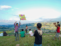 Kids fly kites on the occasion of the Dashain festival in the outskirts of Kathmandu, Nepal, on October 7, 2024. (