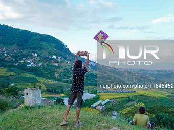 Kids fly kites on the occasion of the Dashain festival in the outskirts of Kathmandu, Nepal, on October 7, 2024. (