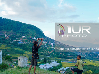 Kids fly kites on the occasion of the Dashain festival in the outskirts of Kathmandu, Nepal, on October 7, 2024. (