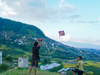 Kids fly kites on the occasion of the Dashain festival in the outskirts of Kathmandu, Nepal, on October 7, 2024. (