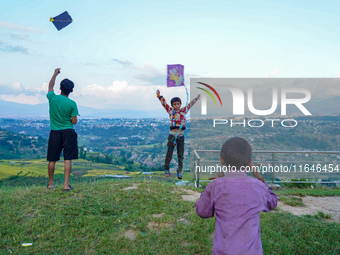 Kids fly kites on the occasion of the Dashain festival in the outskirts of Kathmandu, Nepal, on October 7, 2024. (