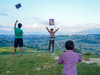 Kids fly kites on the occasion of the Dashain festival in the outskirts of Kathmandu, Nepal, on October 7, 2024. (