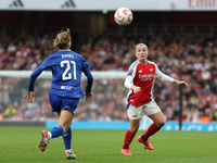 Everton's Veatriki and Arsenal's Kim Little eye the ball during the Barclays FA Women's Super League match between Arsenal and Everton at th...