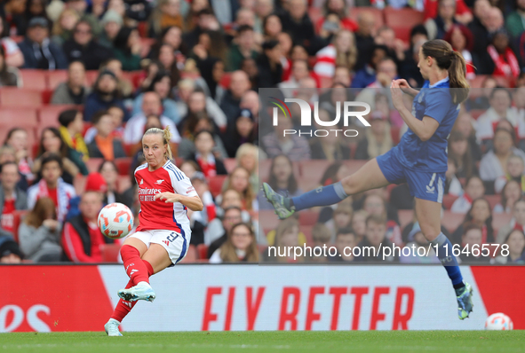 Bath Mead of Arsenal kicks the ball as Everton's Clare Wheeler jumps to block during the Barclays FA Women's Super League match between Arse...