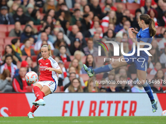 Bath Mead of Arsenal kicks the ball as Everton's Clare Wheeler jumps to block during the Barclays FA Women's Super League match between Arse...