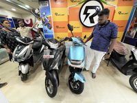 A person looks at an electric scooter at a showroom in Kolkata, India, on October 7, 2024. (