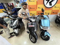 A person looks at an electric scooter at a showroom in Kolkata, India, on October 7, 2024. (